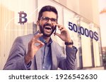 Bitcoin going over 50.000 $ mark,. Happy Businessman finding out good news over the phone. All time high
