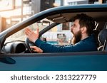 Small photo of Aggressive bearded Caucasian man yelling and shouting in traffic, road rage concept