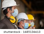 Workers Wear Protective Face...