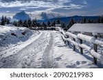winter landscape with snow-covered road - blue sky -
