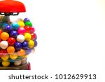 Colorful Gumball Vending Machine with candy on white background with copy space.
