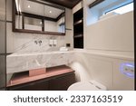 Small photo of Superyacht Interior, guest cabin bathroom with marble tops, toiled and mirror