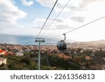 Beautiful panoramic view of the city of Funchal with houses, ocean, mountain and cable cars on the island of Madeira