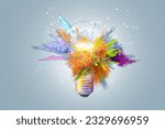 Creative concept light bulb explodes with colorful water colors on a light blue background. Think different, creative idea. Productivity and creativity