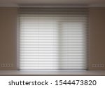 Pleated blinds XL, beige color, with 50mm fold close up in the window opening in the interior. Luxury sun protection and window decoration. Modern shades.