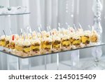 closeup of mini dessert pudding trifles arranged elegantly on a dessert table for a wedding party dinner
