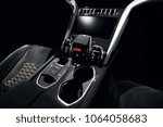 Supercar carbon dashboard interior in dark with start and stop button and glass holder Lamborghini hypercar style