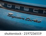 Small photo of Riga, LV - APR 24, 2020: Porsche Taycan Turbo first luxury electric auto logo at the thunk lid