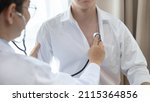 Small photo of Male doctor uses a stethoscope to check his breathing and lung health to check the patient's initial symptoms, Attending an annual health check in a hospital or clinic, Healthcare and medical concept.
