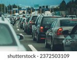 Large queue of vehicles on motorway pay toll in summer, selective focus