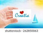 Summer Vacation on Croatia Beach, Person Holding Visiting Card for Summertime Holiday Message Love Croatia and Sailboat at Sea in Background.
