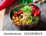 Vegan Buddha bowl with chickpeas, courgette, sundried tomatoes and sprouts