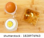 Small photo of Two Boiled Eggs & Hot Buttered Toast on a wood background, go to work on an egg with brown toast and hot melted butter, Light English Breakfast