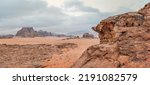 Small photo of Red orange Mars like landscape in Jordan Wadi Rum desert, mountains background, overcast morning. This location was used as set for many science fiction movies
