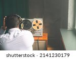 Small photo of Secret agent listens on the reel tape recorder. Officer wiretapping in headphones. Spying of conversations. Intelligence gathering. Espionage concept. Report information to superiors.
