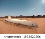 An old submarine is stuck in the sand of the desert