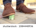 Man stepping in chewing gum on sidewalk. Concept of stickiness