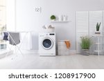 Laundry room interior with washing machine near wall