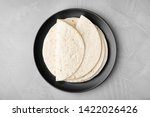 Small photo of Plate with corn tortillas on grey background, top view. Unleavened bread