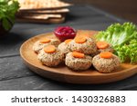 Plate of traditional Passover (Pesach) gefilte fish on wooden table, closeup