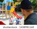 Suspicious adult man spying on kids at playground, space for text. Child in danger