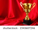 golden trophy cup on red fabric.... | Shutterstock . vector #1543607246