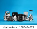 Set of different household appliances on light blue background