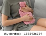 Woman Using Hot Water Bottle To ...