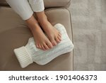 Woman Warming Feet With Hot...