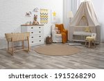 Small photo of Stylish baby's room with comfortable cot. Interior design