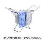 Clean laundry hanging on drying rack against white background