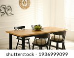 Stylish wooden dining table and ...