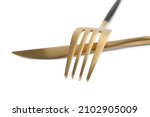 New golden fork and knife on white background, closeup