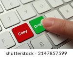 Woman pressing green button with word Original on computer keyboard, closeup. Plagiarism concept