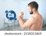 Small photo of Role of calcium for human. Young man suffering from pain in wrist, digital compositing with illustration of arm bone