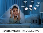Young woman trying to fall asleep counting sheep in bed at night