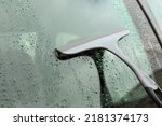 Wiping car window with drying blade outdoors, closeup