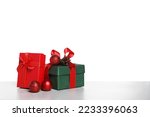 Christmas gifts in beautiful decorated boxes on grey table against white background, space for text
