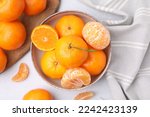 Fresh juicy tangerines on light grey table, flat lay