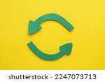 Paper curved arrows on yellow background, flat lay. Space for text