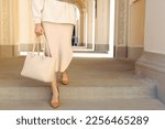 Young woman with stylish bag outside, closeup. Space for text