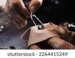 Professional jeweler working with gemstone, closeup view