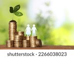 Small photo of Pension concept. Elderly couple illustration, coins and sprout on wooden table. Space for text