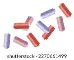 Many colorful sewing threads falling on white background