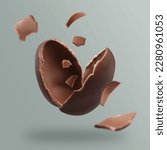 Small photo of Exploded milk chocolate egg on grey background