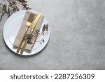 Stylish table setting with cutlery and eucalyptus leaves, top view. Space for text