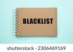 Small photo of Word Blacklist written in notepad on light blue background, top view