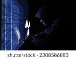 Small photo of Nuclear deterrence. Hacker using computer in darkness, virtual screen with code and warning radiation symbol