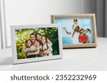 Framed family photos on white...