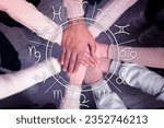 Relationships and horoscope. Zodiac wheel and photo of people joining hands together, closeup